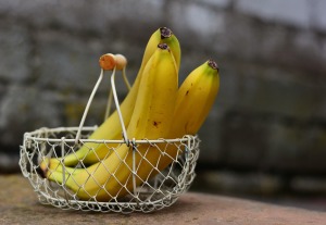 Image of three whole bananas in a wire basket